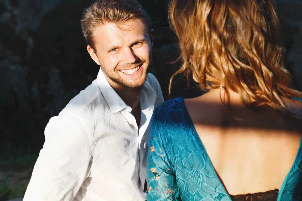 Attract The One man looking at woman and smiling