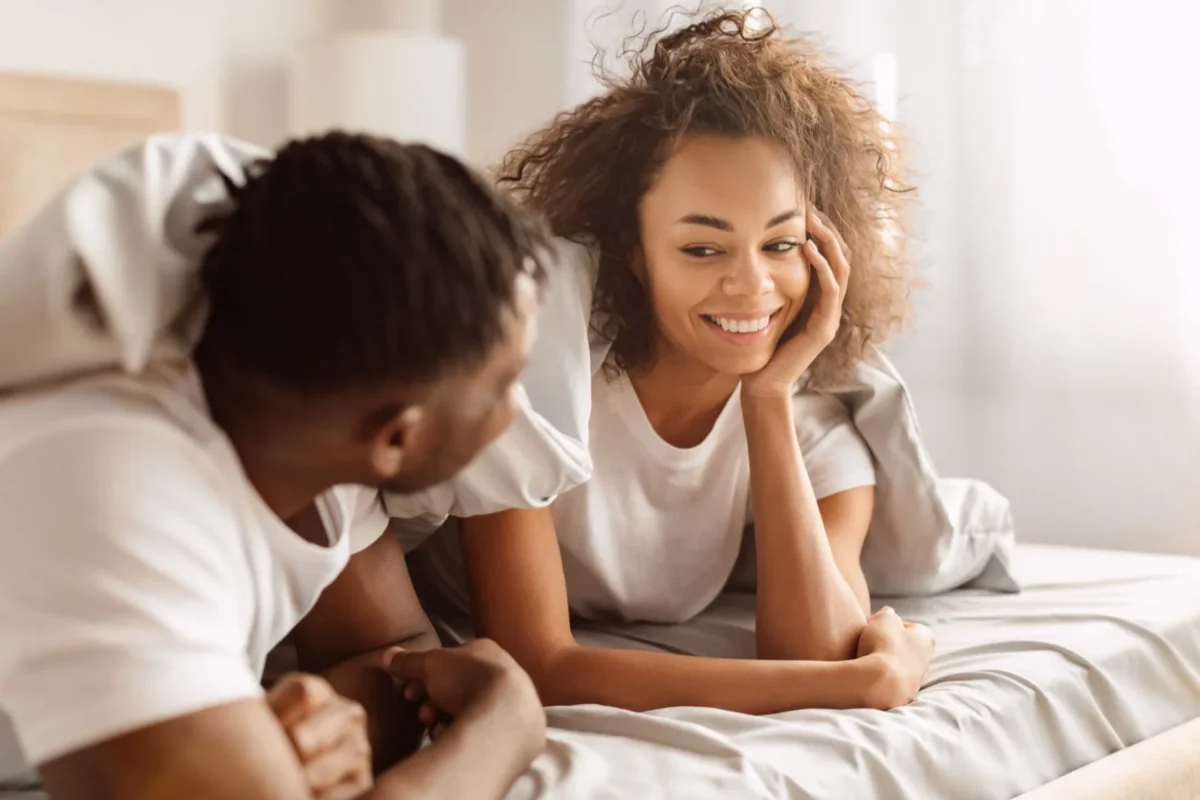 woman flirting with man in bed