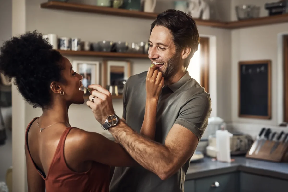 5 Things Men Want More Than Sex playful couple feeding each other