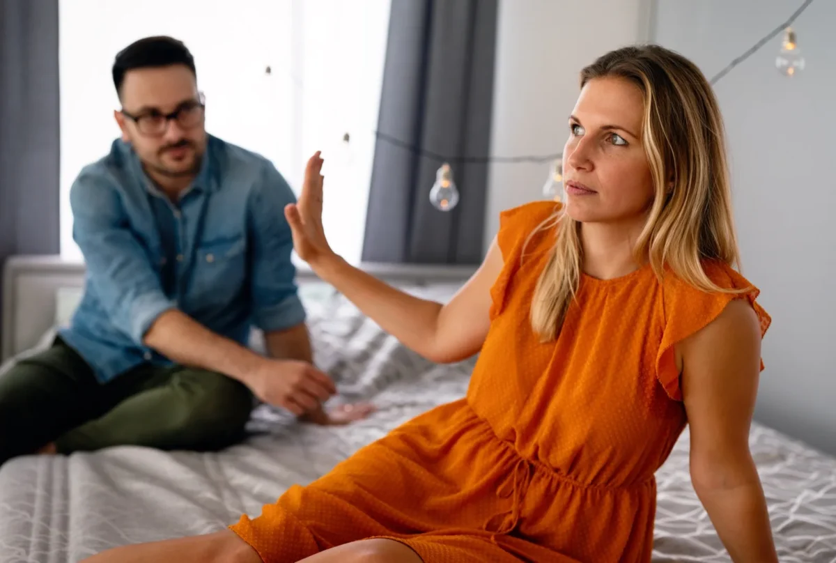woman refusing to listen to man with hand up