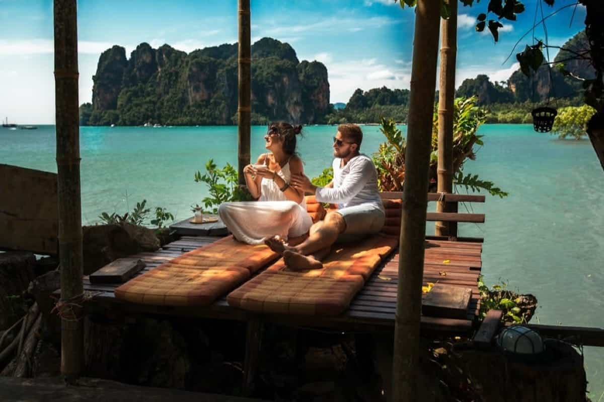 romantic couple in beautiful tropical ocean front lounge