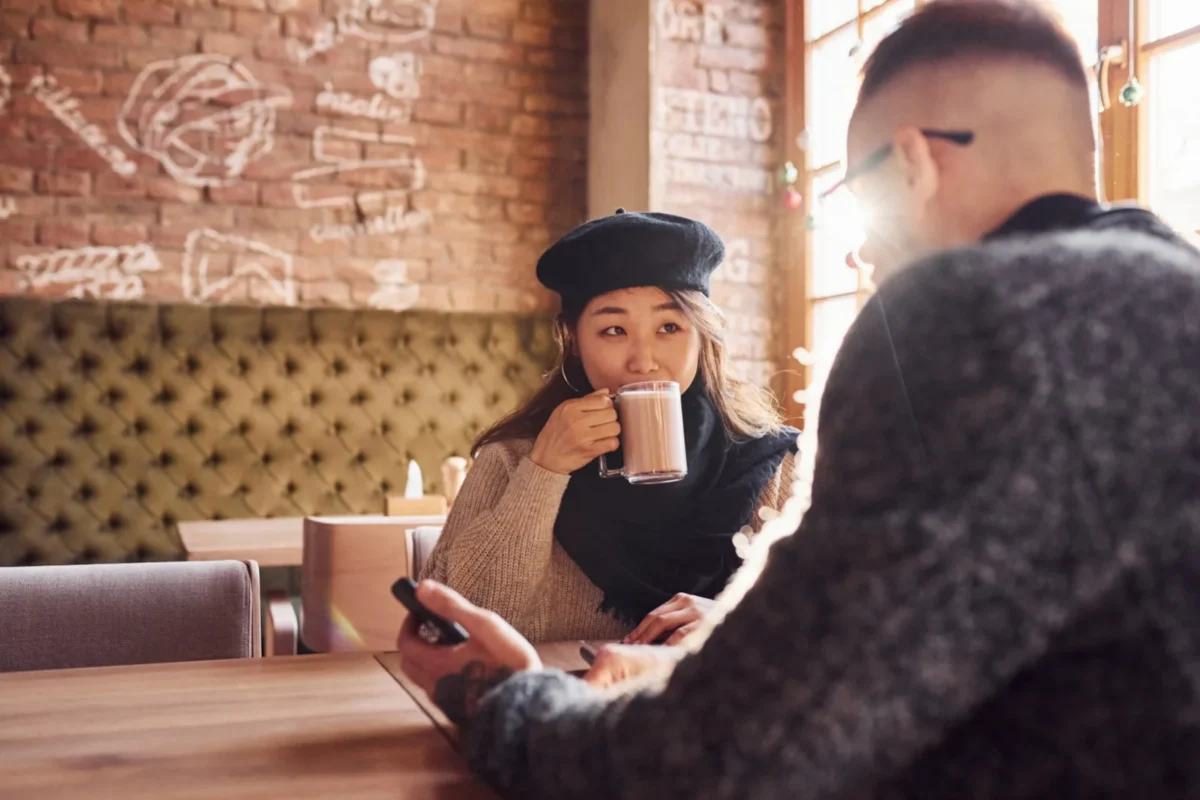 How To Get Back Together With An Introvert woman sitting in coffee shop with man