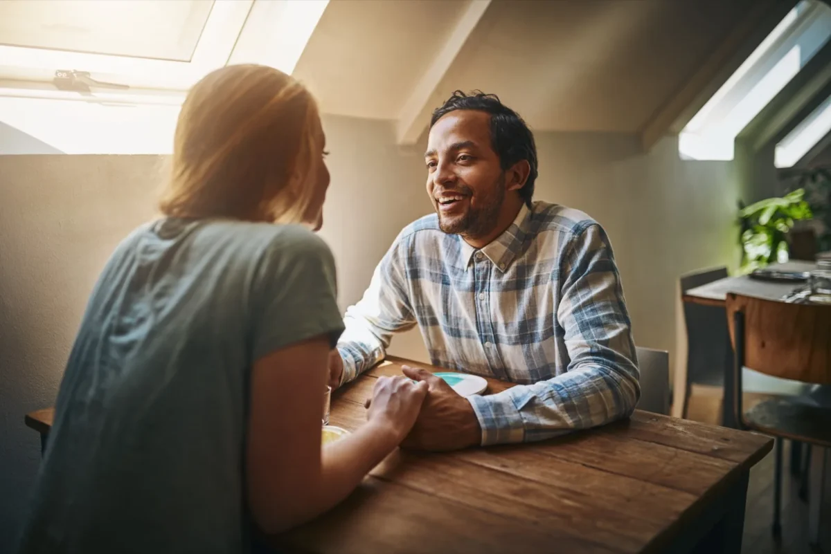 couple talking intimately at table