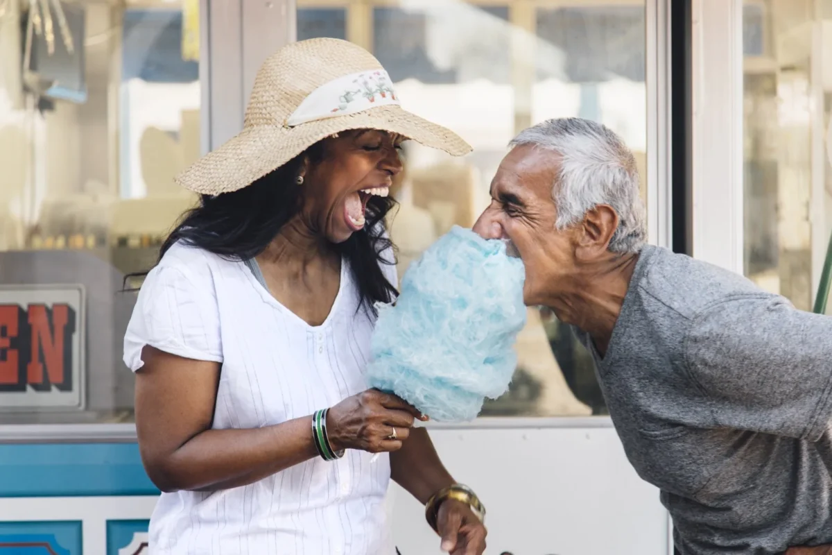 man eating woman's cotton candy