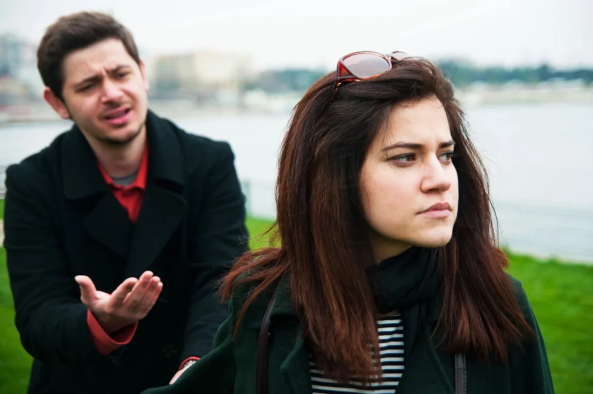 unreliable man following woman arguing