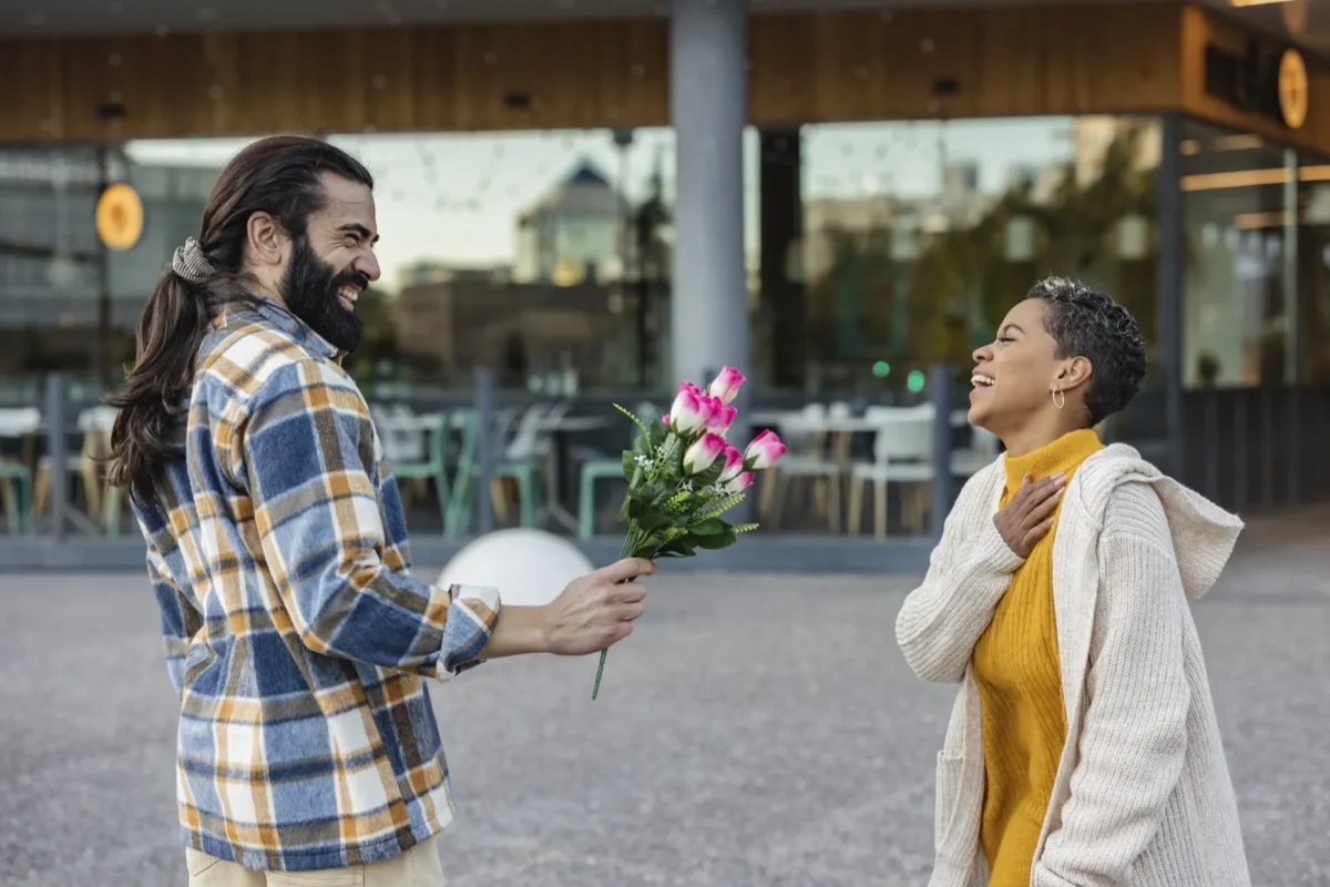 man giving woman flowers