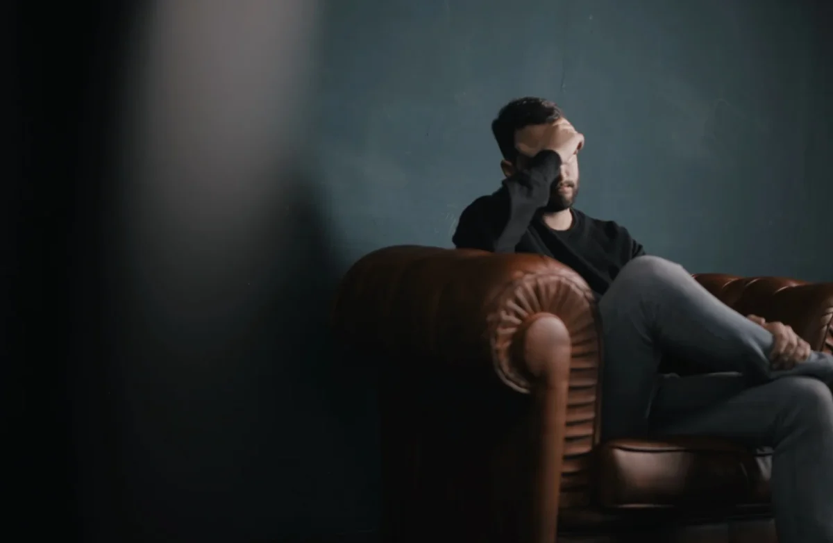 man covering face