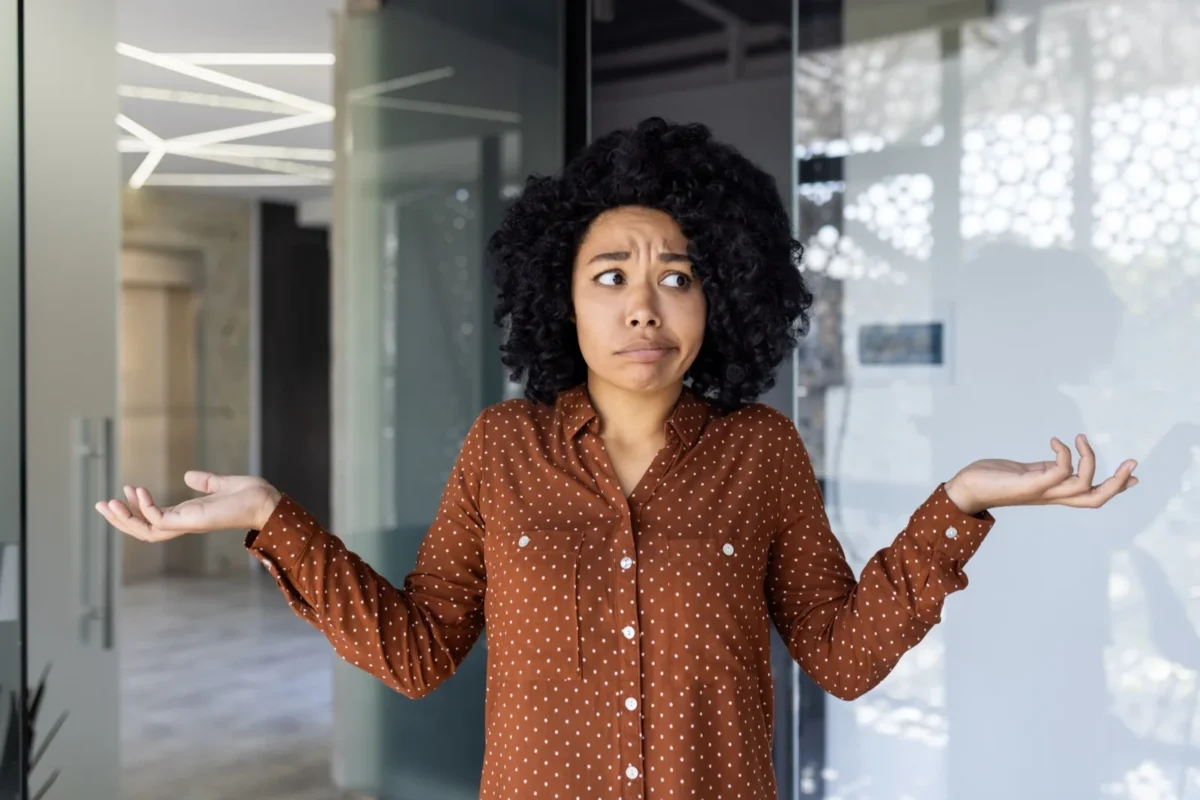 10 Things Single Women Are SO Tired of Hearing (And How To Fire Back) woman with unsure expression making confused hands