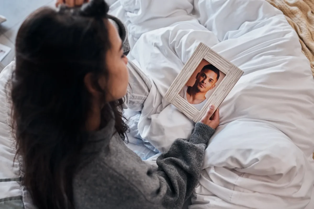 woman looking at framed photo