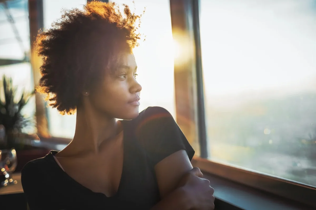 5 Things You Need To Do NOW To Be Happily In Love (Whether You're Single or Coupled Up) woman looking out window alone