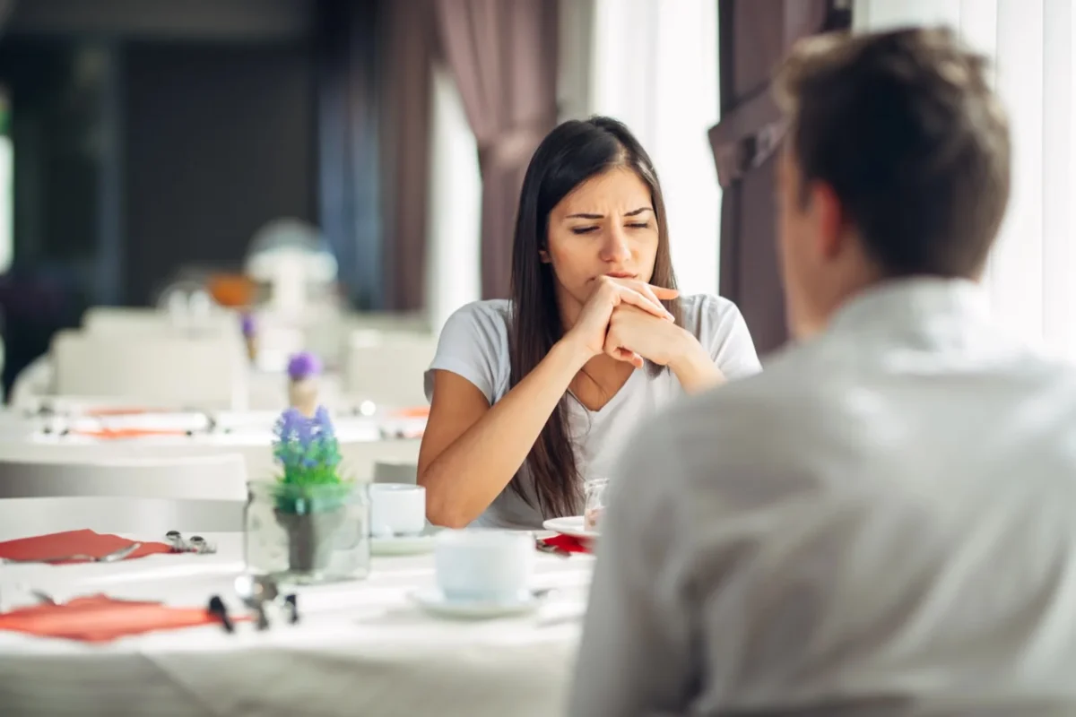 woman sitting at table in silence