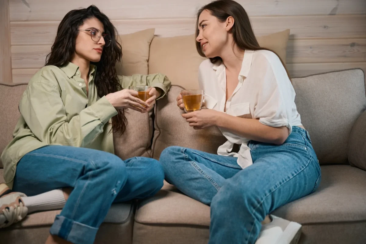 women talking on couch venting to each other