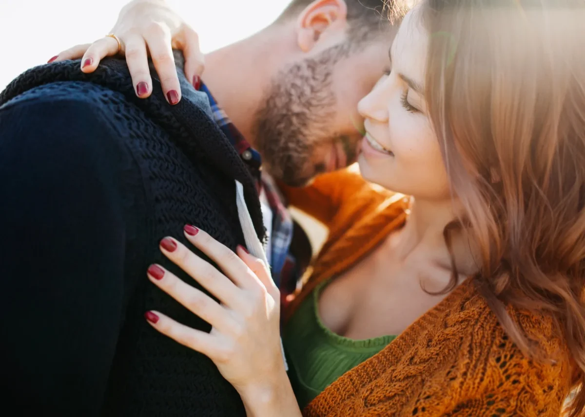 man embracing woman