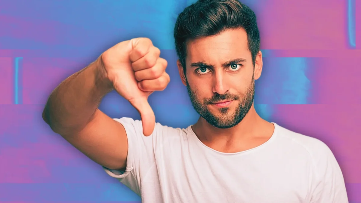 man making thumbs down sign