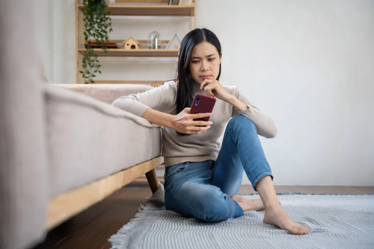 puzzled woman looking at phone