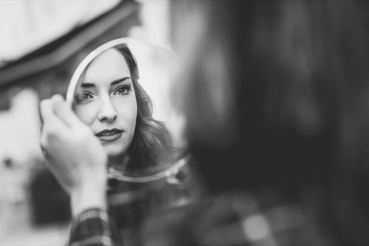 woman looking in mirror