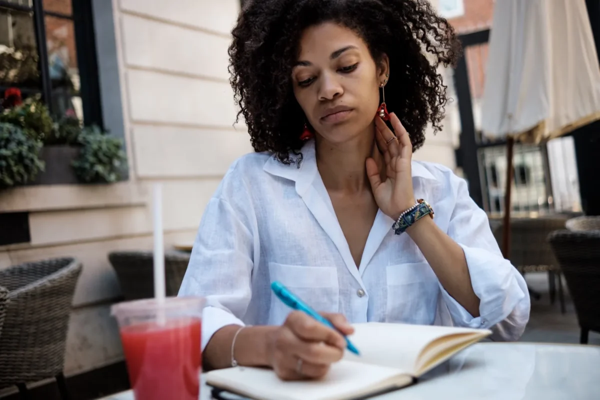 13 Crucial Ways To Show Your Husband You Appreciate Him woman writing in notebook outside