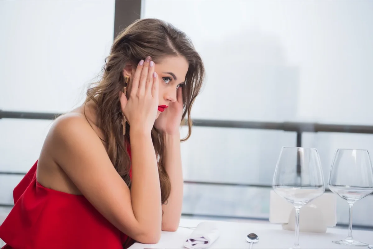 annoyed woman waiting alone in restaurant