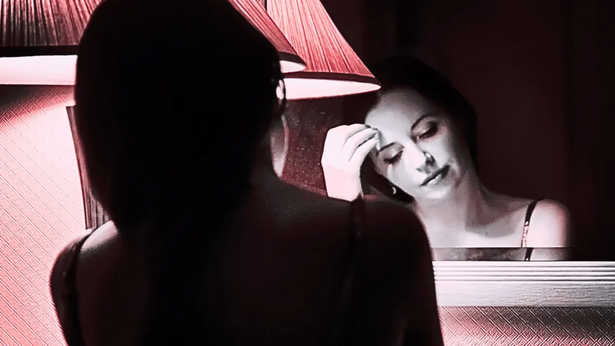 sad woman looking in mirror