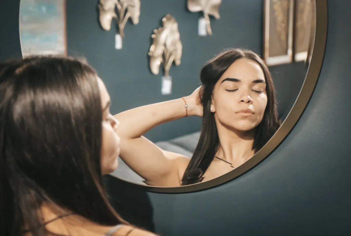 narcissistic woman admiring herself in mirror