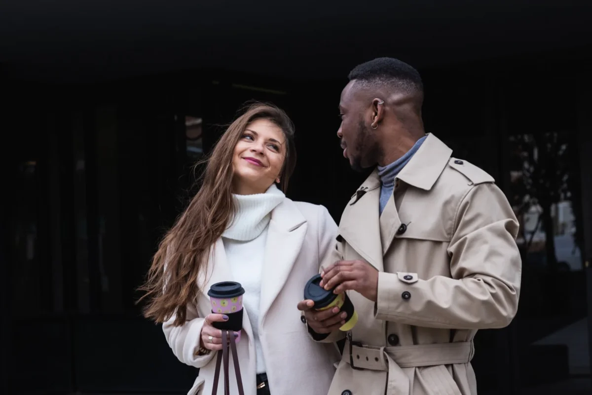 couple communicating holding coffee