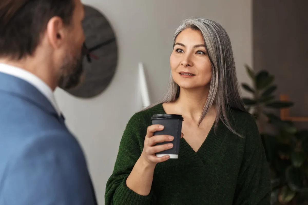 How To Get Back Together With An Introvert woman looking at man holding coffee