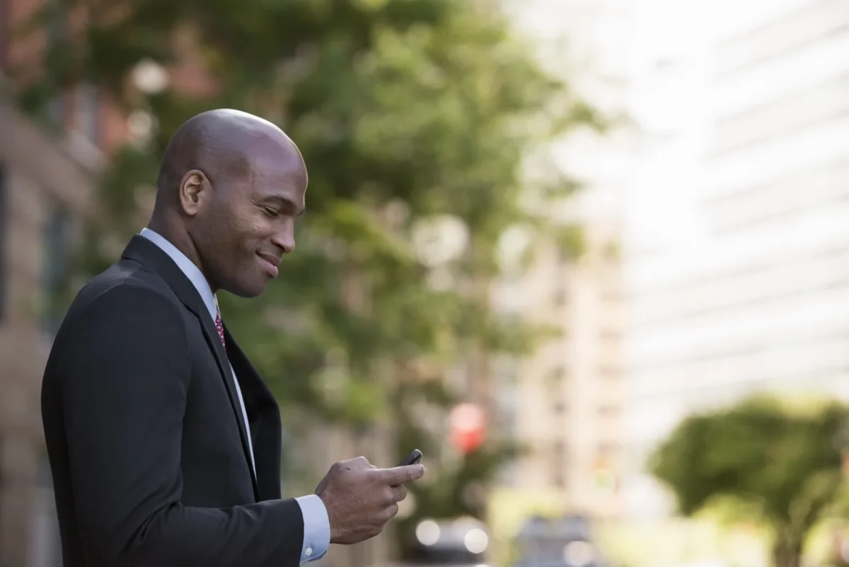 attractive man holding phone and smiling