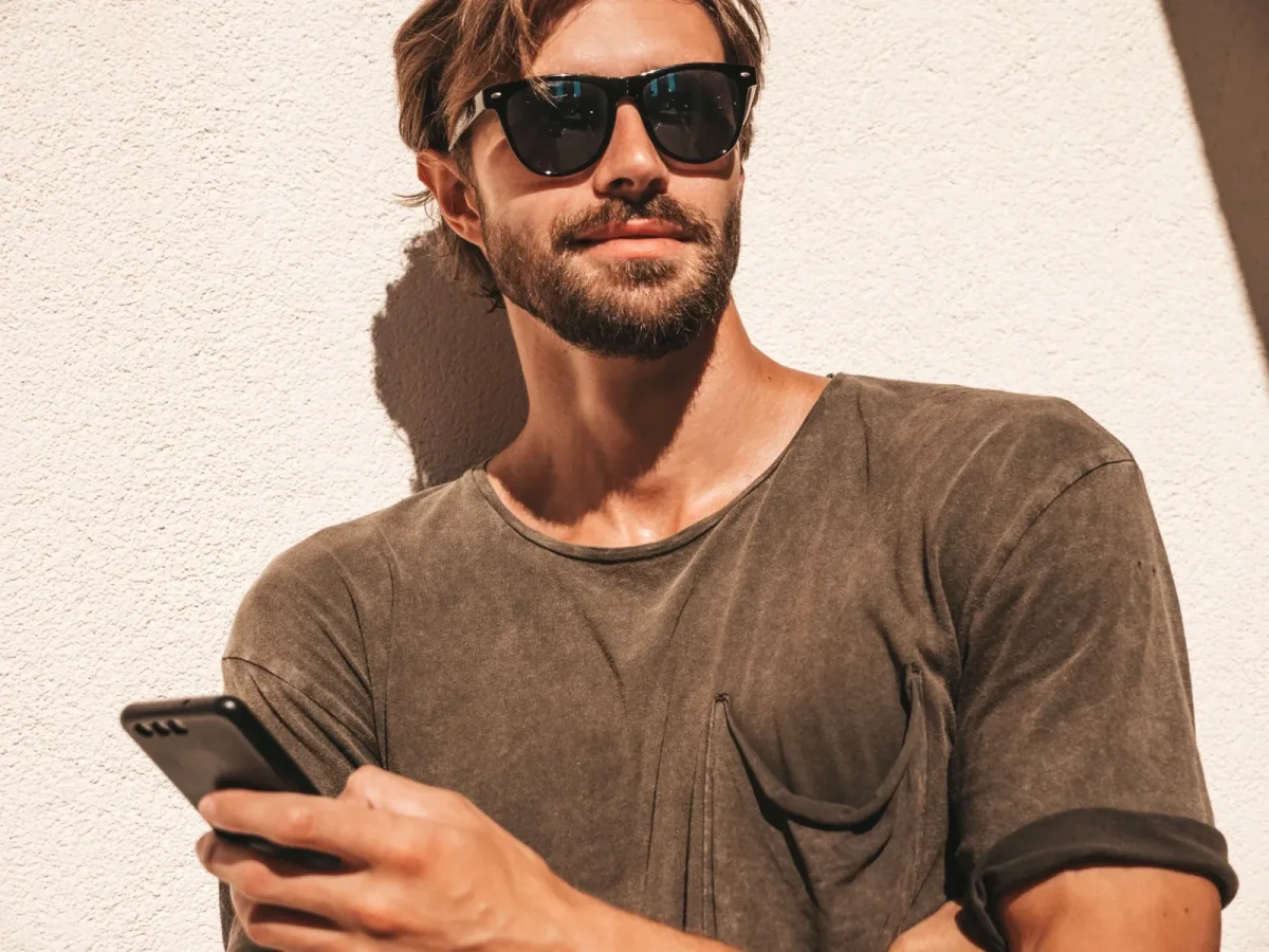 attractive man holding phone