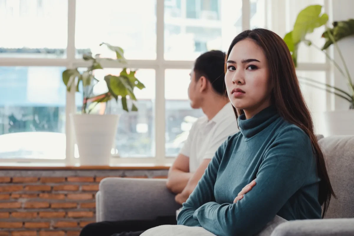 woman with arms crossed away from man