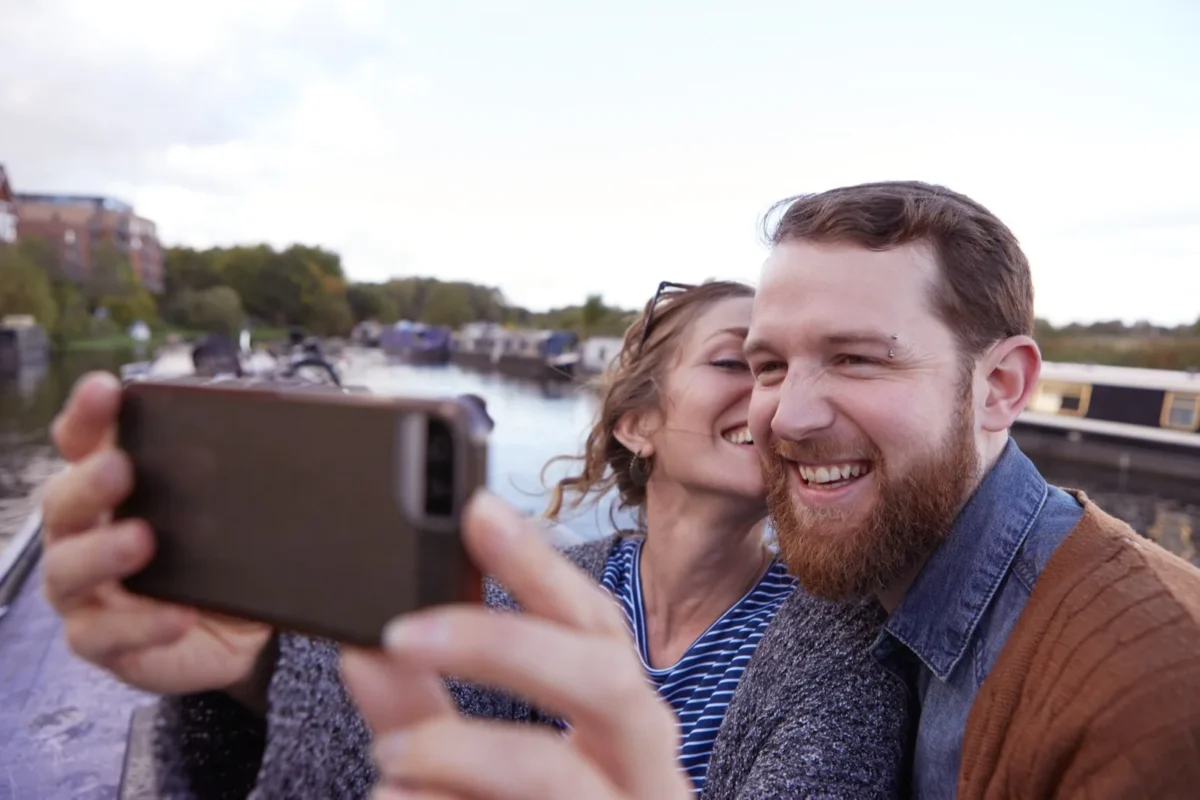 couple smiling and taking selfie