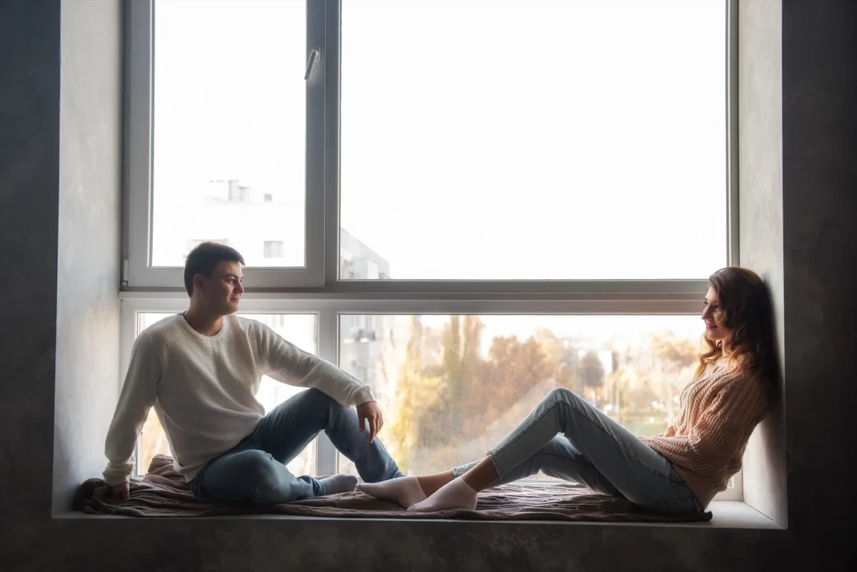 couple sitting together in window nook
