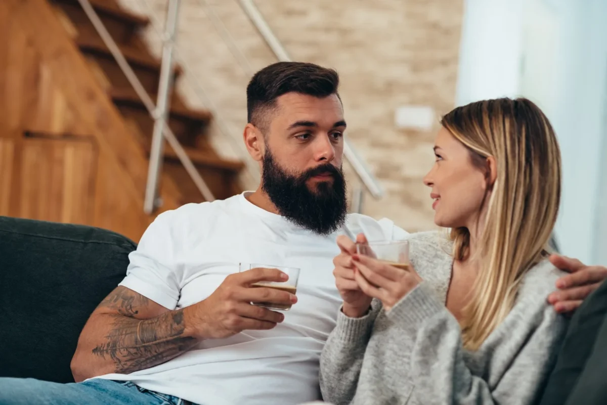 couple talking and sharing drinks