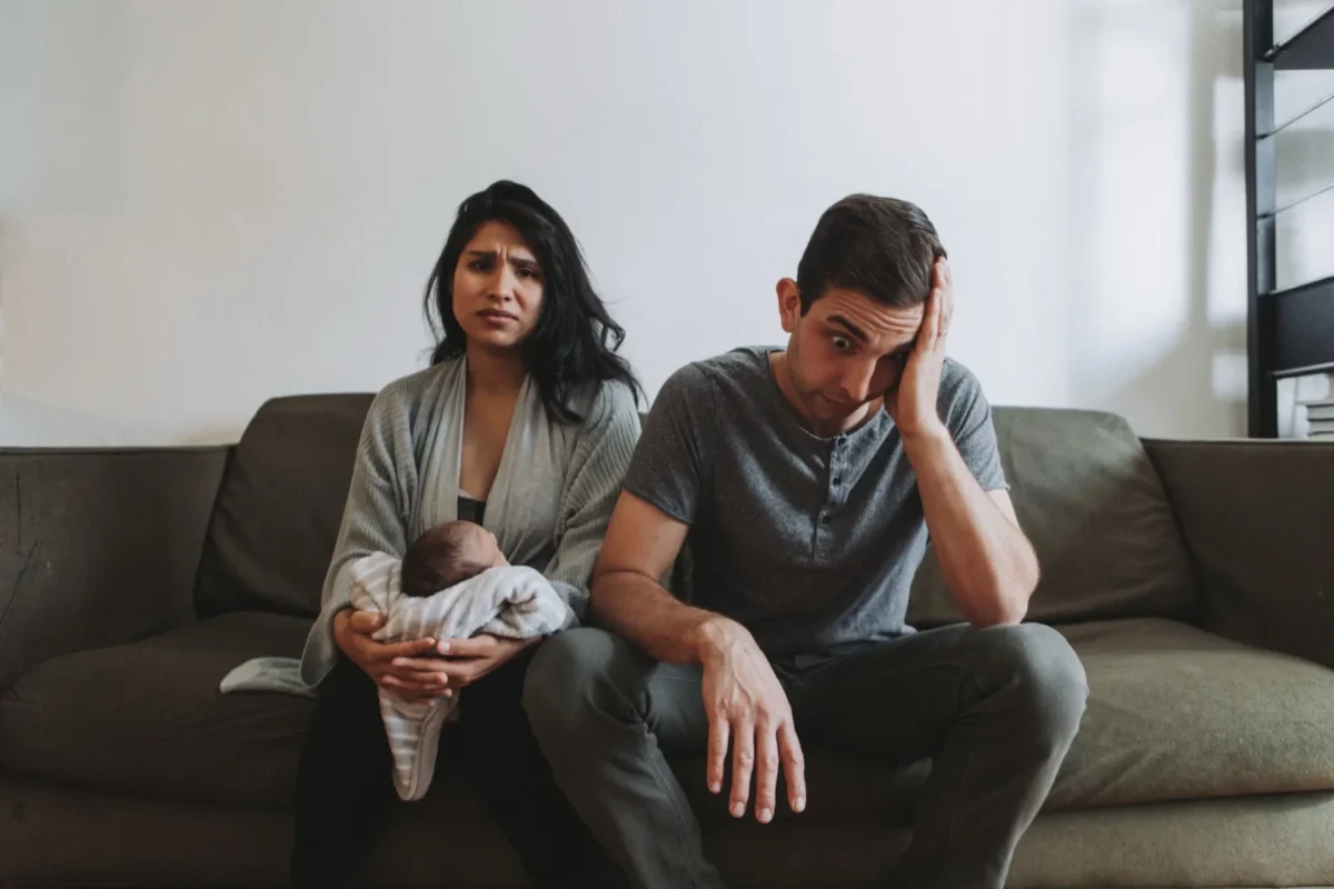 exhausted parents with baby