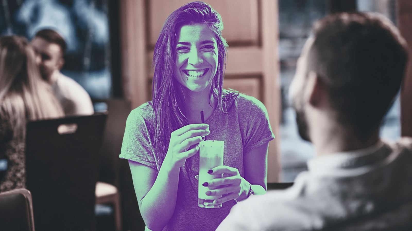 woman drinking coffee smiling at man