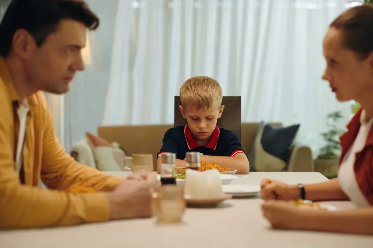 boy with tense parents at dinner table