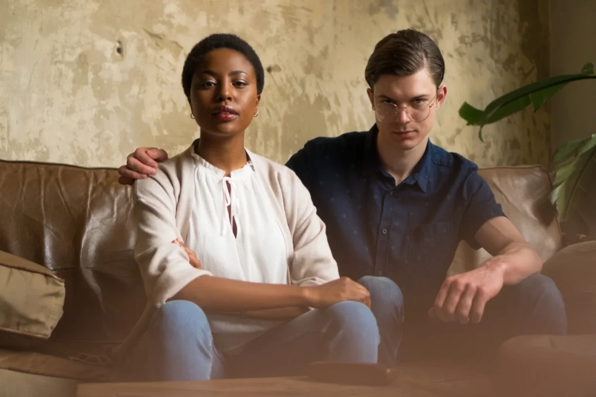 couple together on couch, not happy