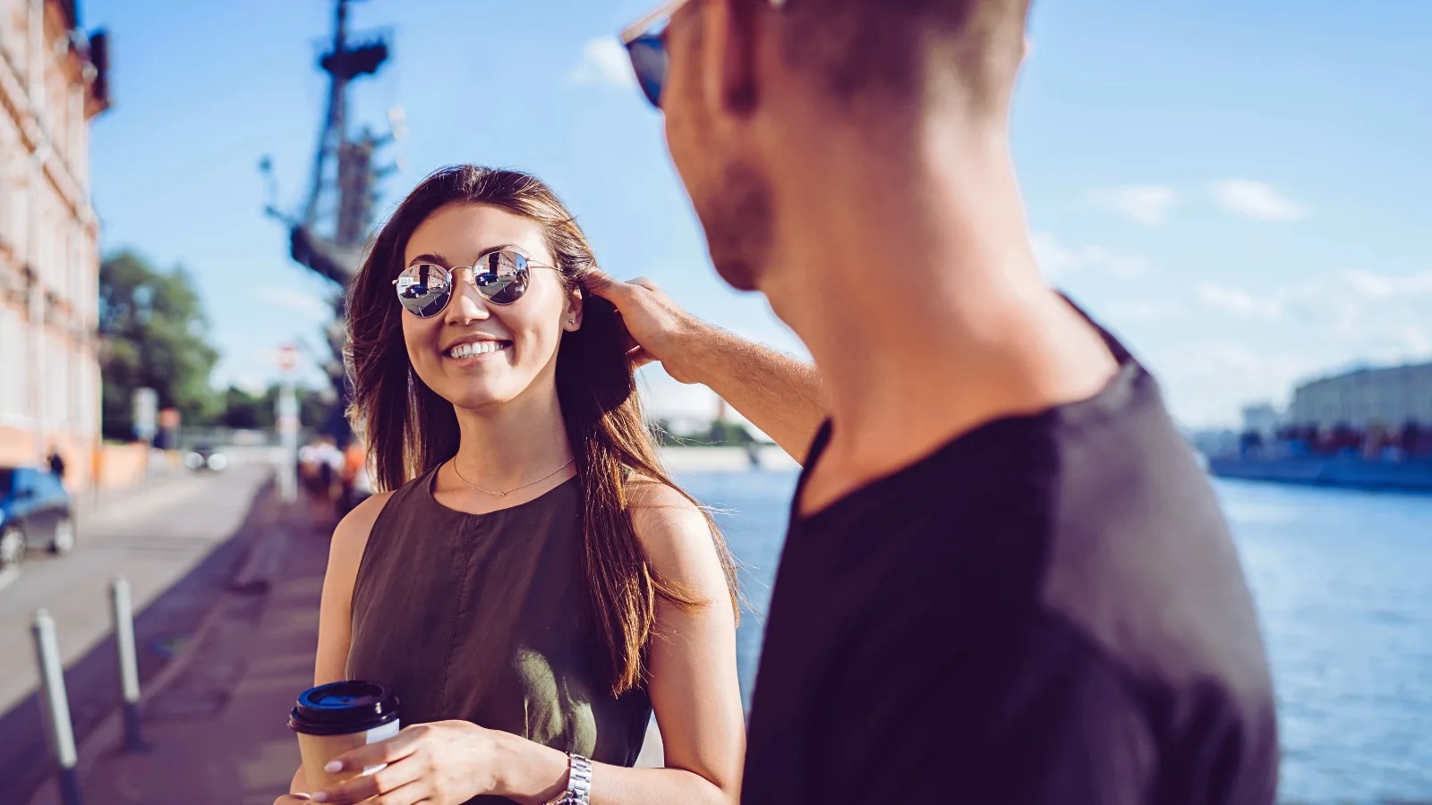 man fixing smiling woman's hair