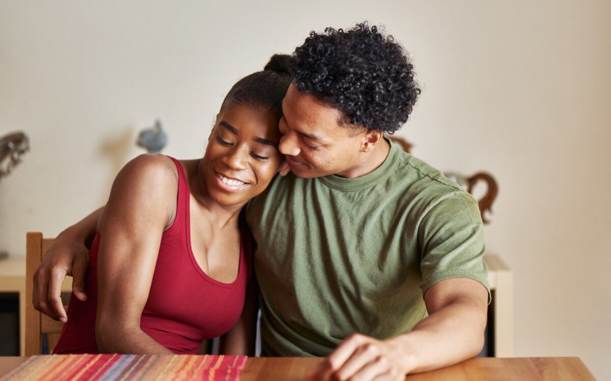couple embracing at kitchen table