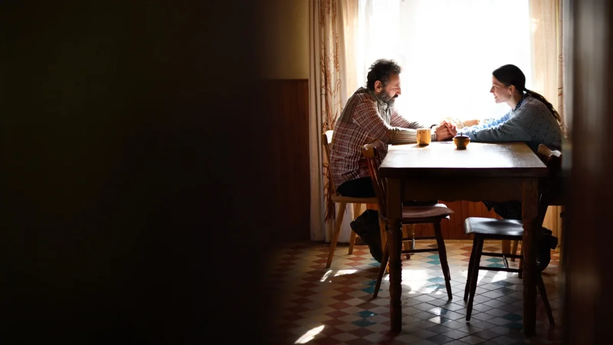 couple holding hands at dining table