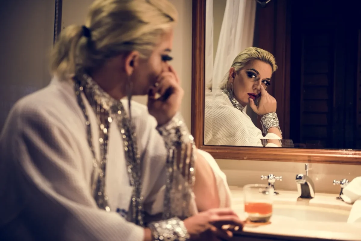 woman looking into mirror