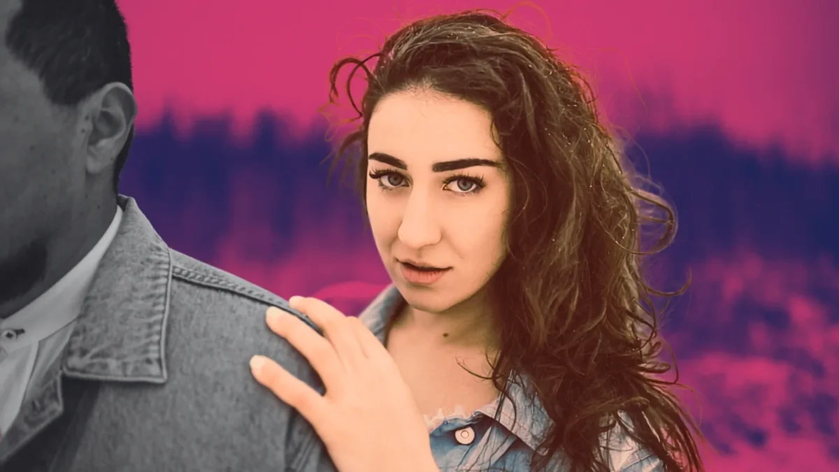 jealous woman holding on to man's shoulder