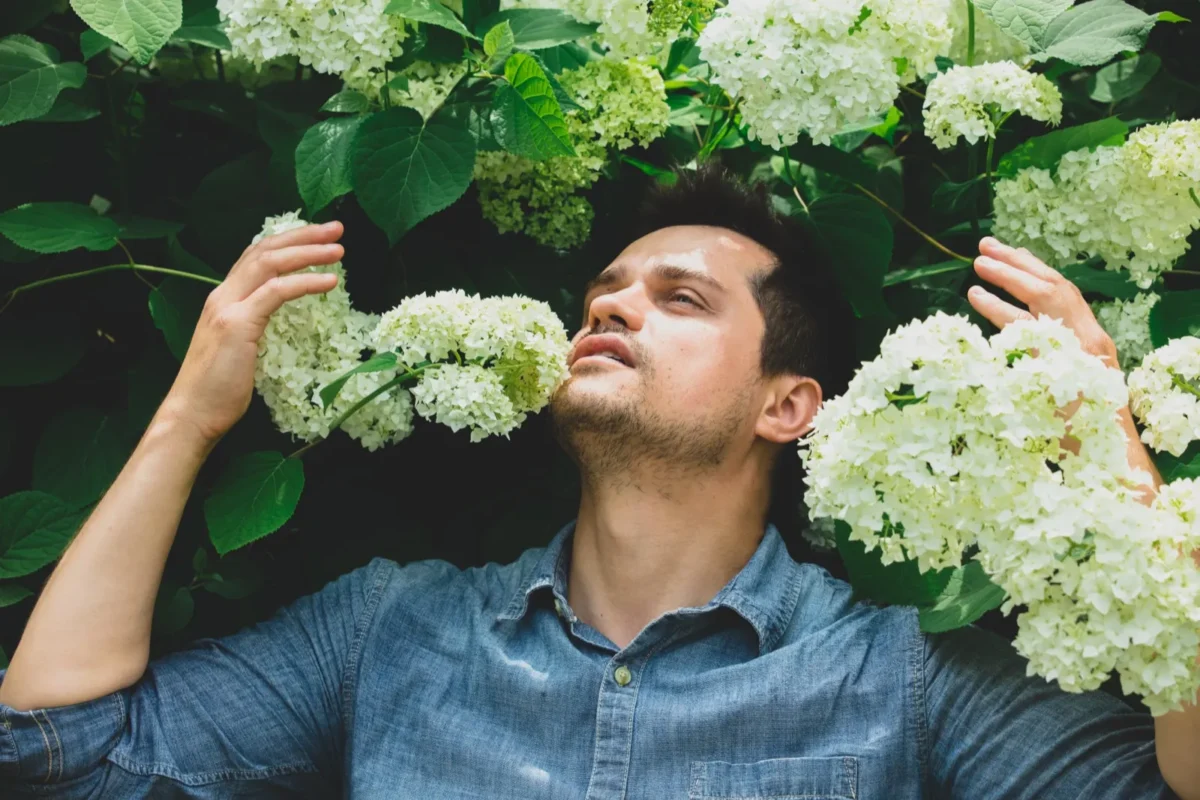 man with white flowers