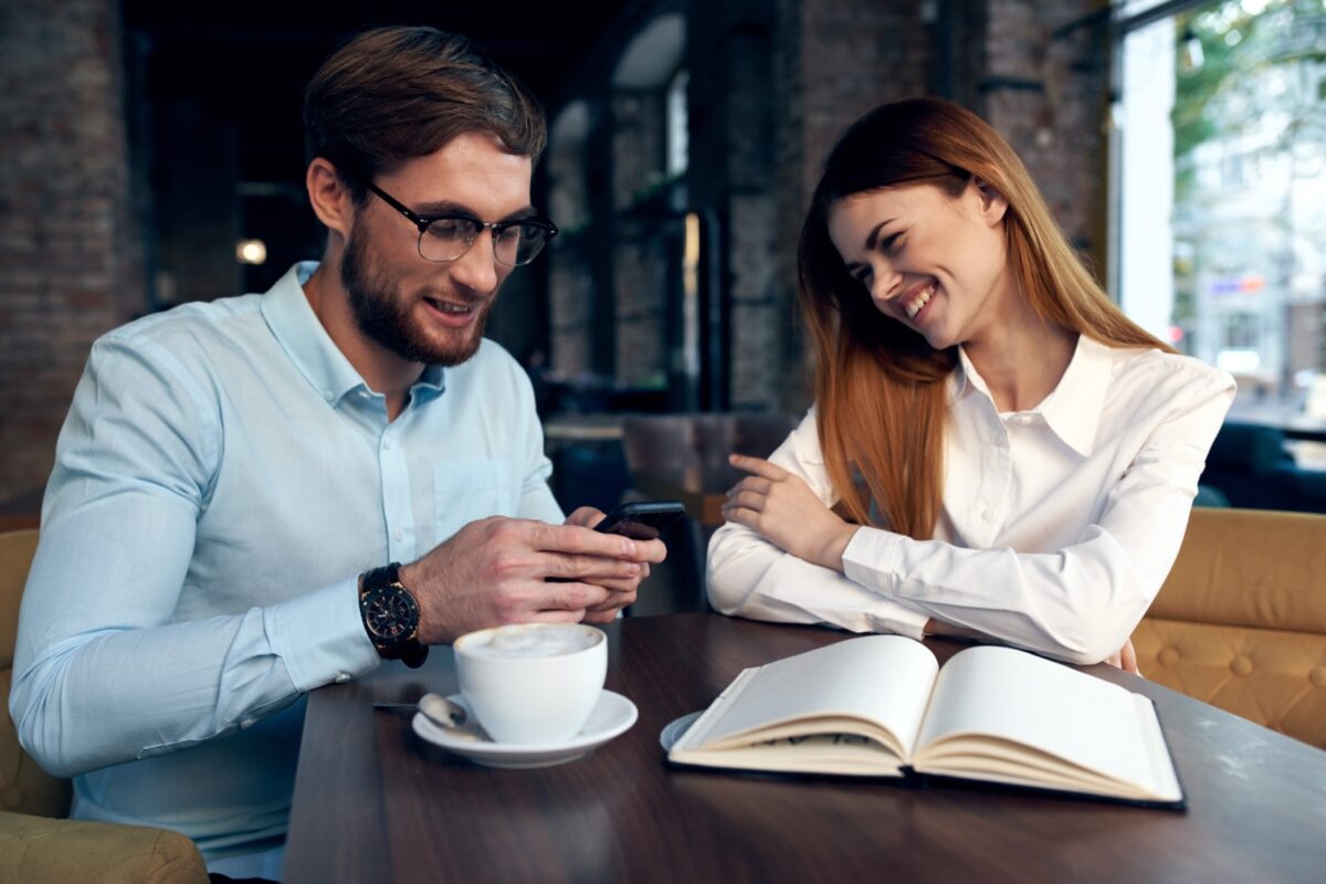 man and woman reading together with coffee