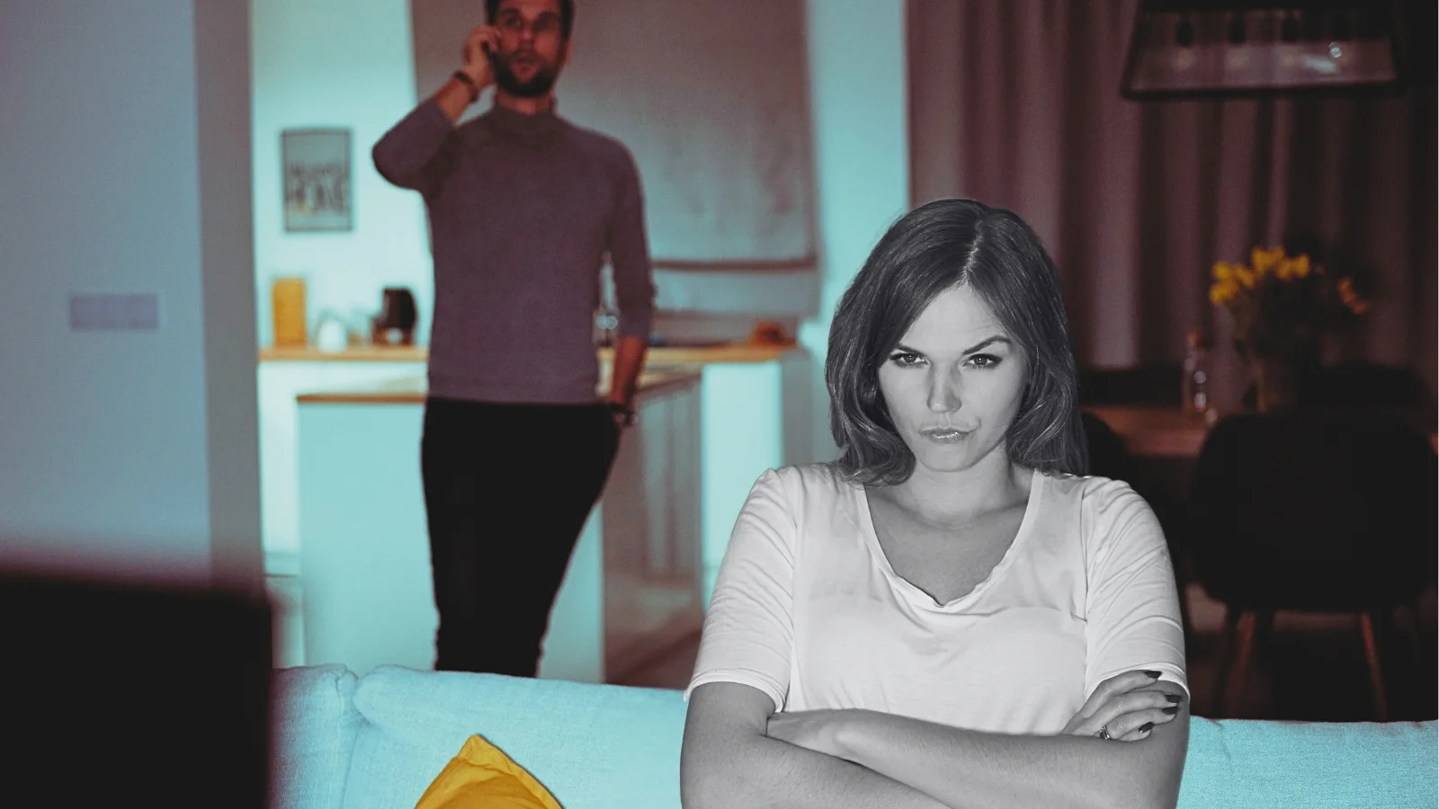frustrated woman watching tv while man talks on phone