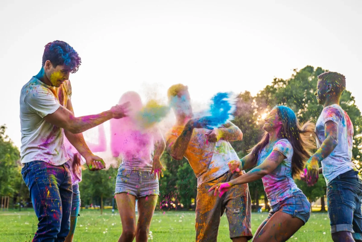 friends playing with colored powder
