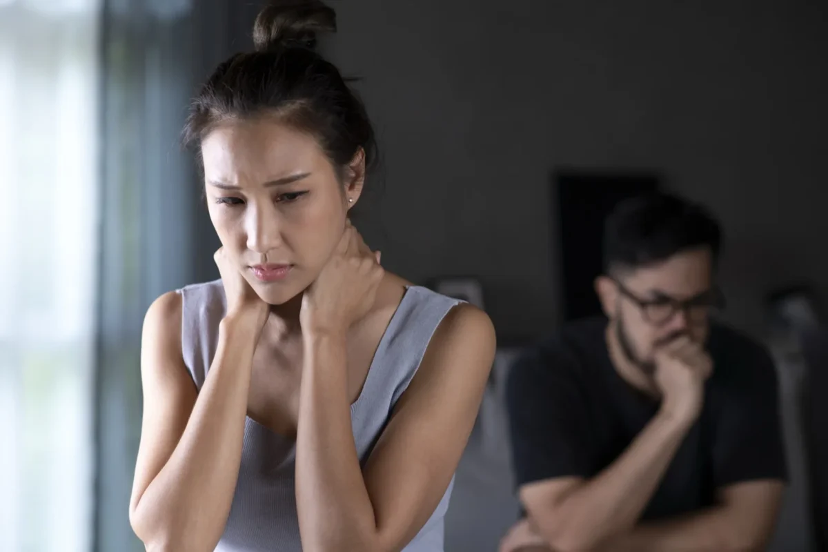 upset woman with partner behind her