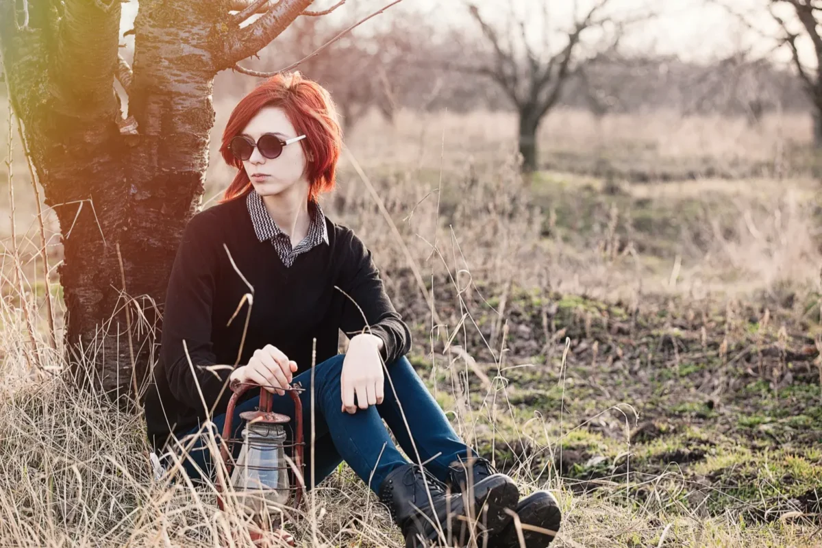 woman leaning against tree