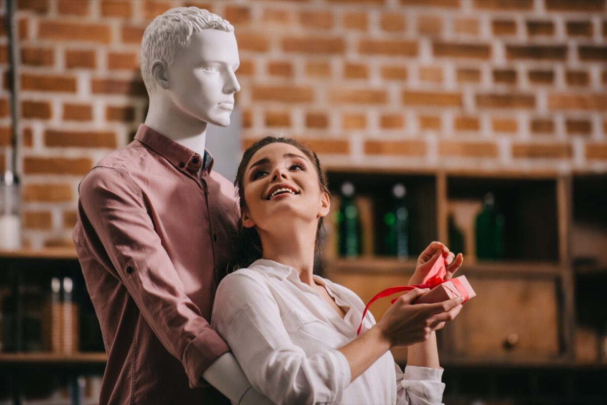 woman looking up at mannequin lovingly