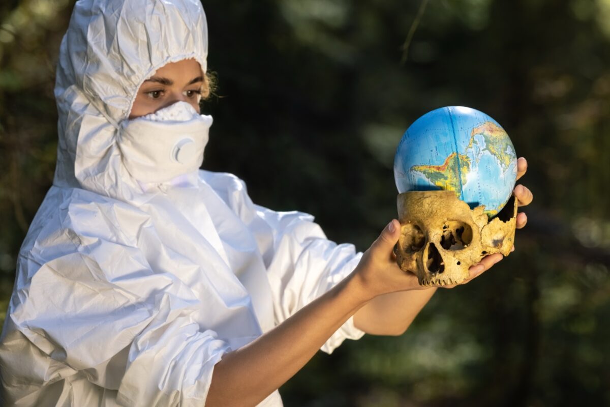 woman holding skull and globe
