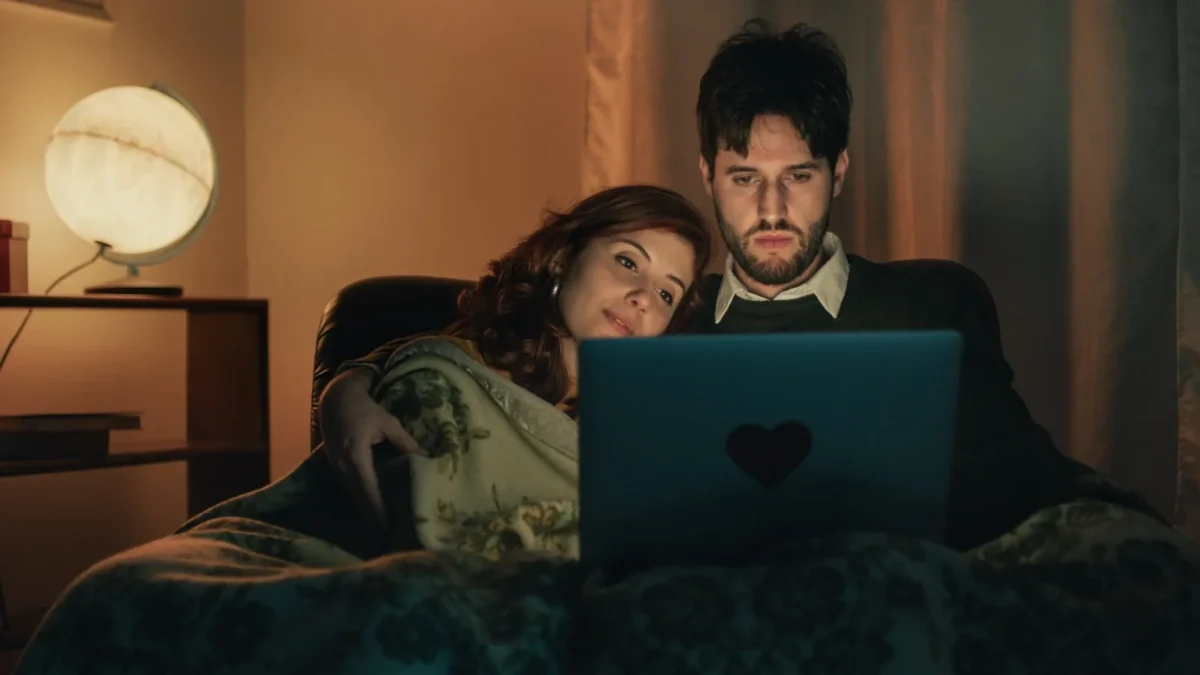 couple cuddling with laptop